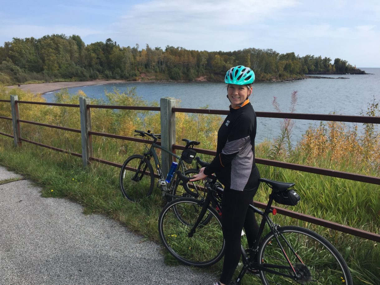 Woman on Bike in front of water