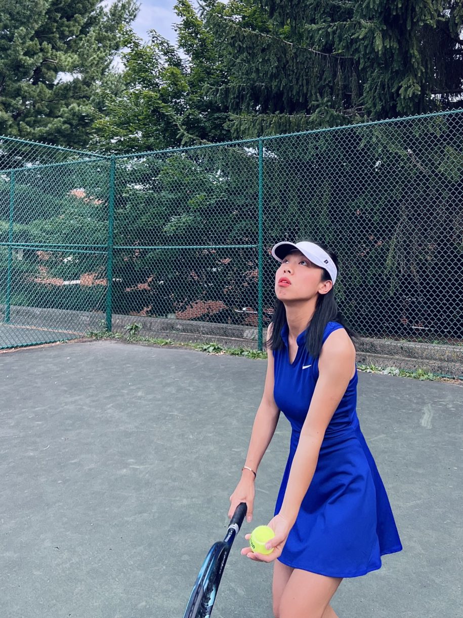 woman about to serve a tennis ball